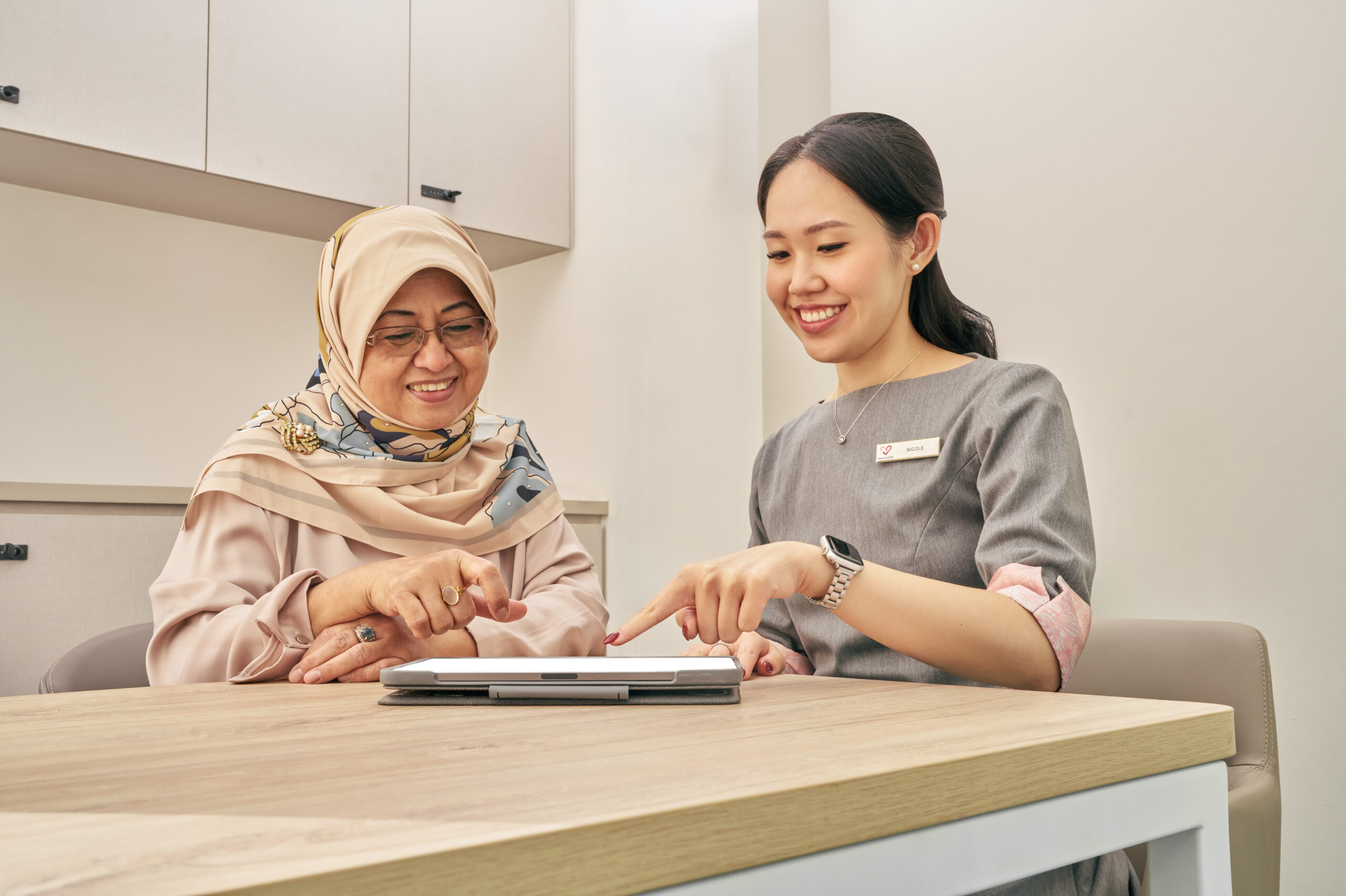 ServiceSG staff helping citizen on tablet