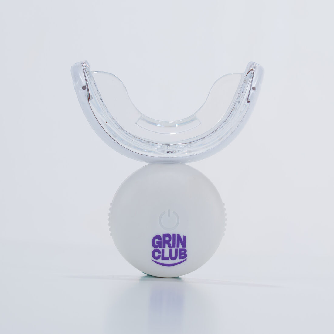 Grin Club LED whitening mouthpiece photographed on a plain white studio background