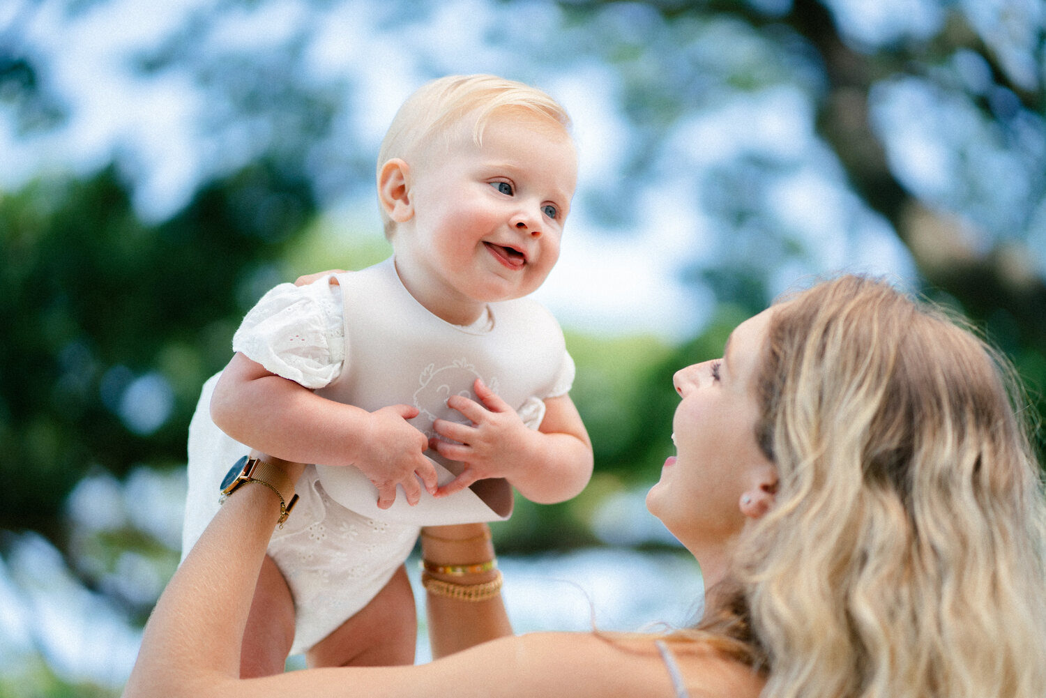 KeaBabies baby held up outdoors by parent — lifestyle photography