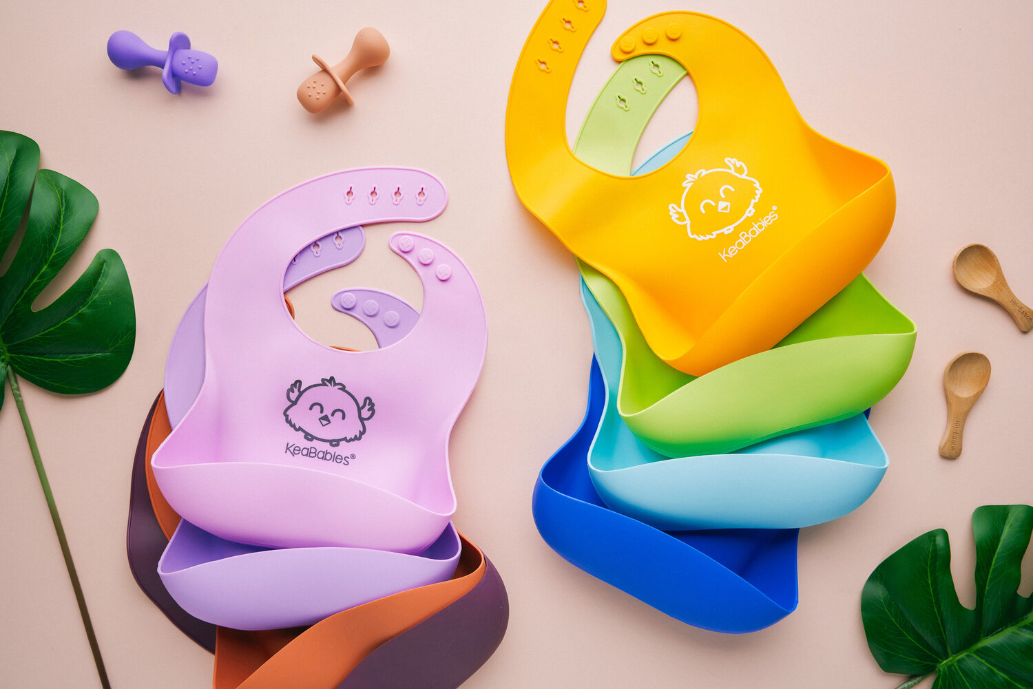 KeaBabies silicone bibs rainbow flat-lay — e-commerce product photography Singapore
