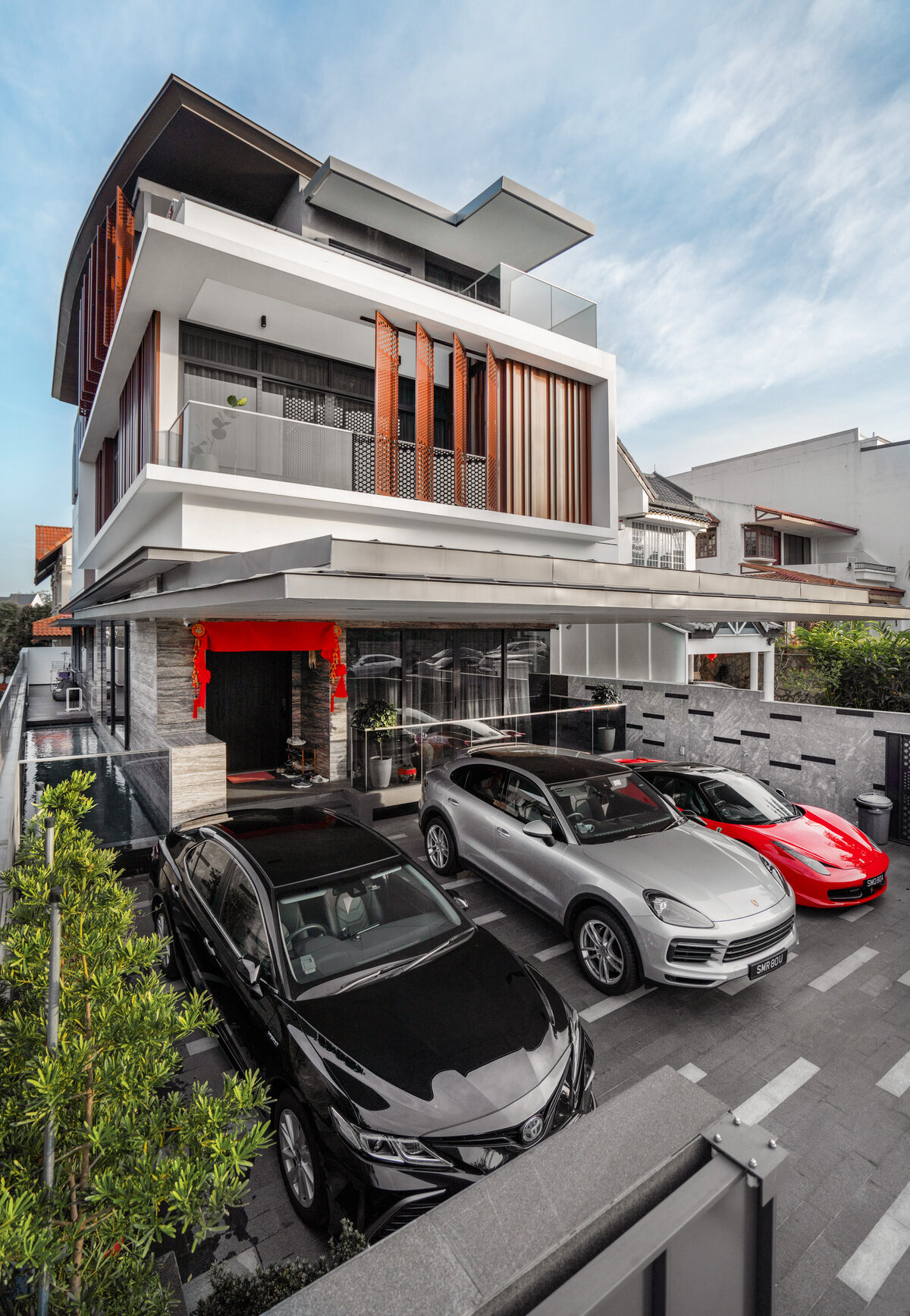 Modern luxury landed home front facade with supercars parked — architecture photography Singapore