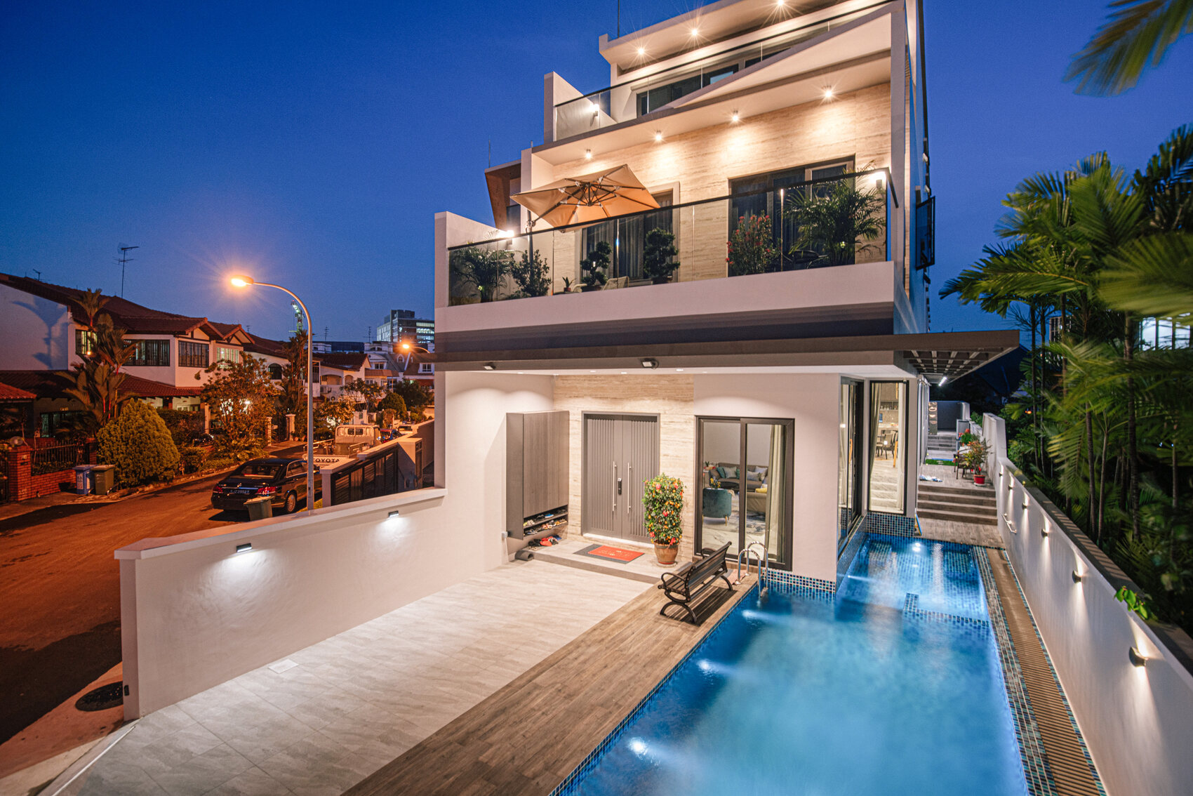 Tai Keng semi-detached home twilight exterior with lit windows and pool — real estate photography Singapore