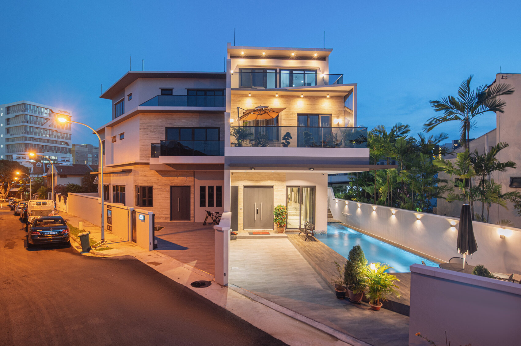 Tai Keng semi-detached home at twilight with lit facade and pool — real estate photography Singapore by GradePixel