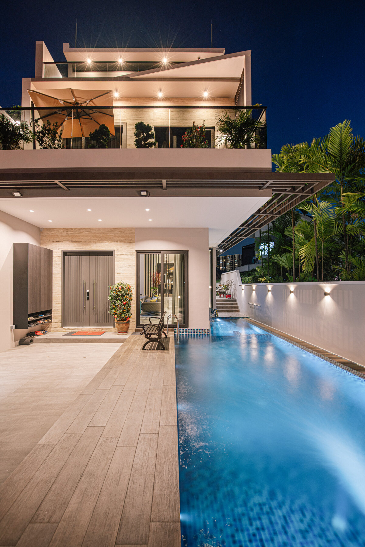 Tai Keng semi-detached home lit pool at twilight — real estate photography Singapore