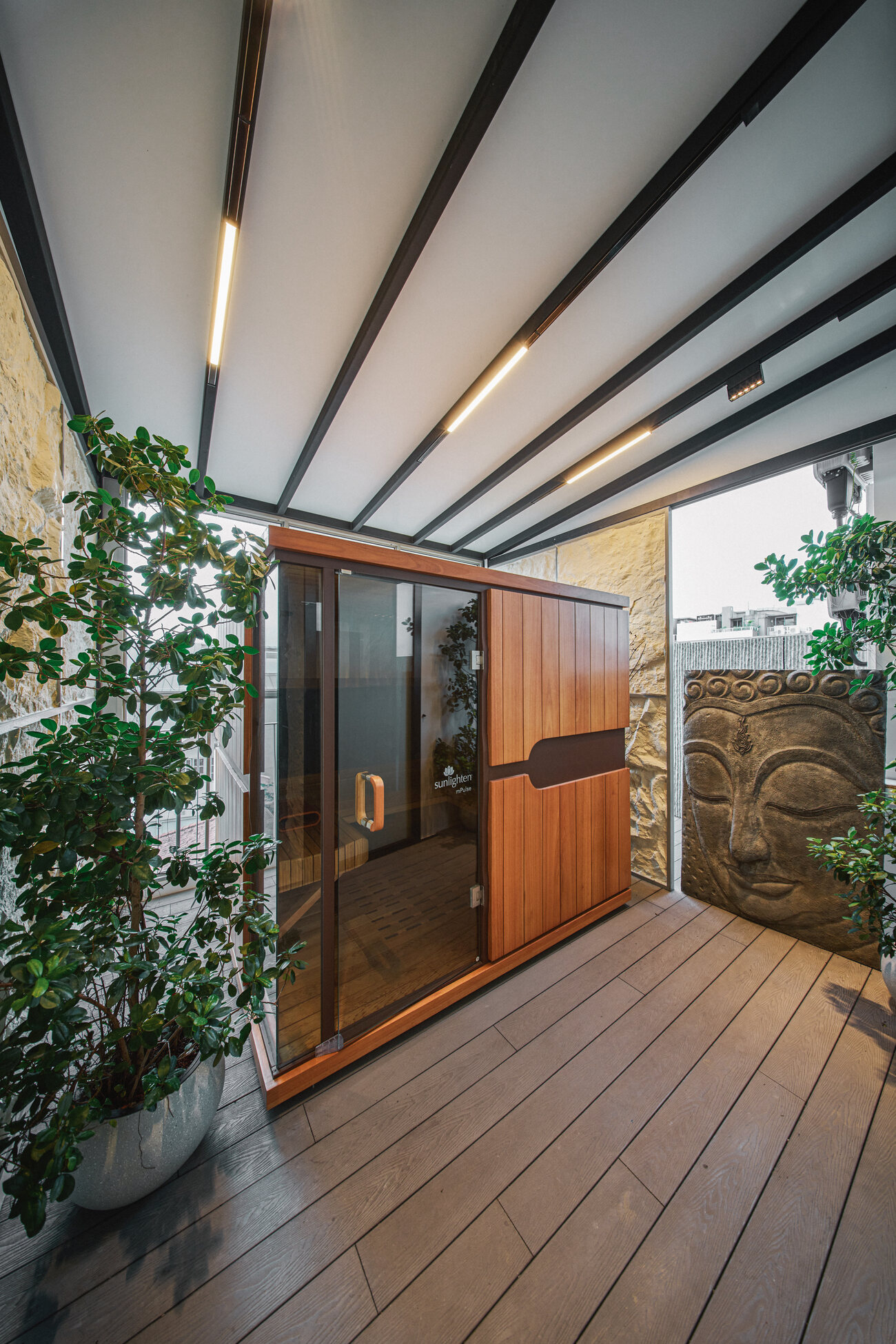 Telok Kurau residence interior photography — a timber-decked courtyard with greenery and a screened entrance