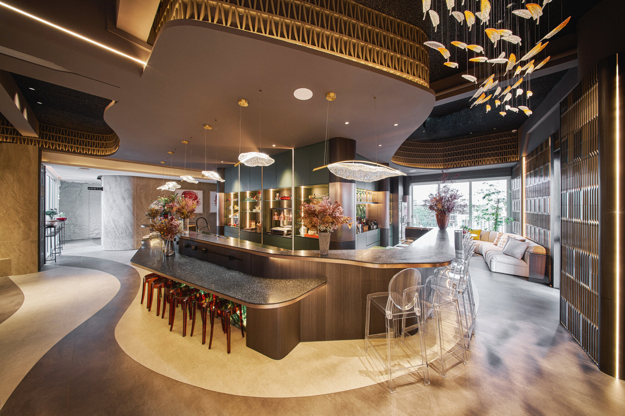Telok Kurau residence interior photography — a curved sculptural bar lounge with a school-of-fish pendant installation, designed by Edwin