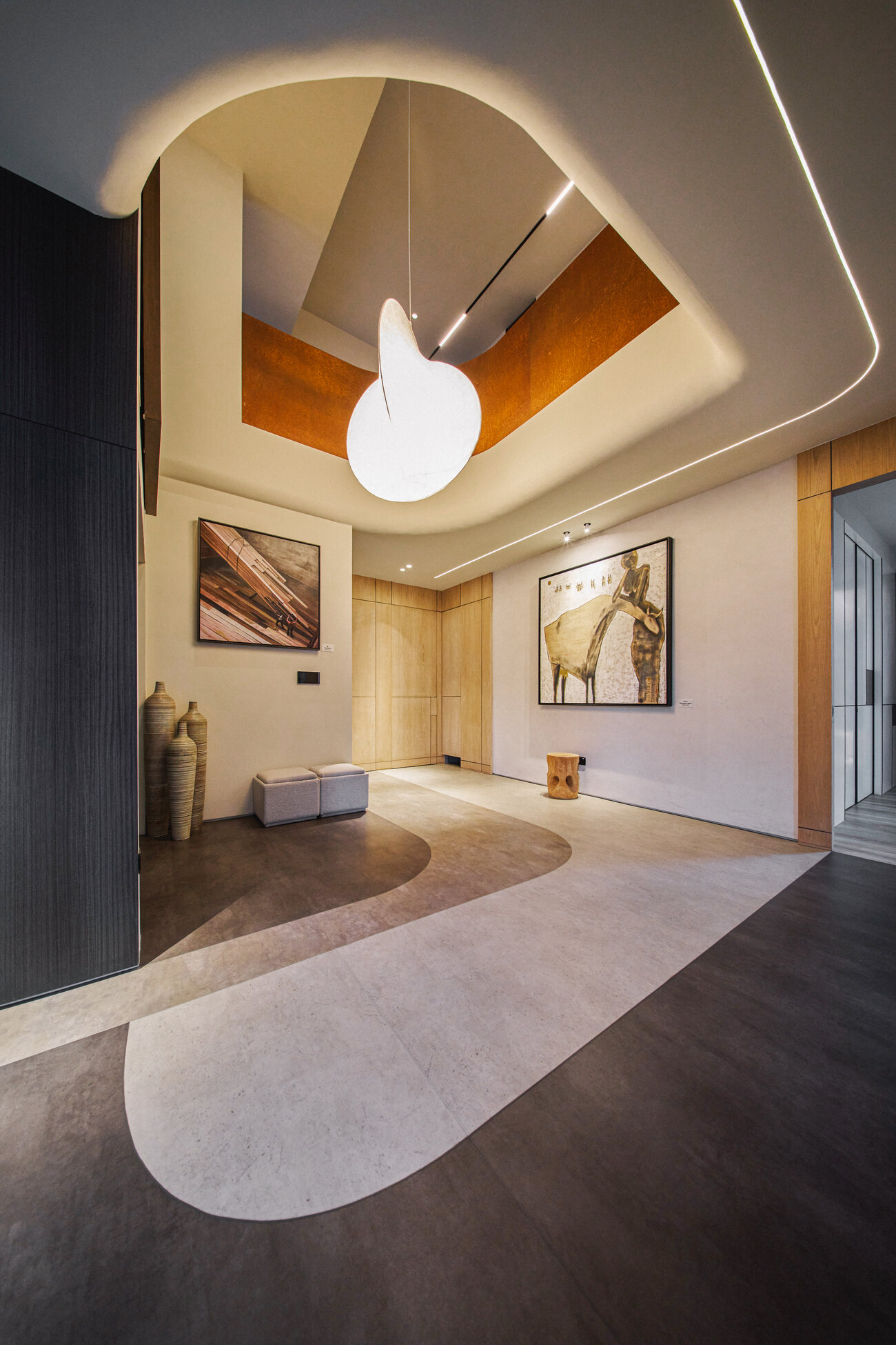 Telok Kurau residence architecture photography — an organic curved void with a sculptural pendant and inlaid flooring